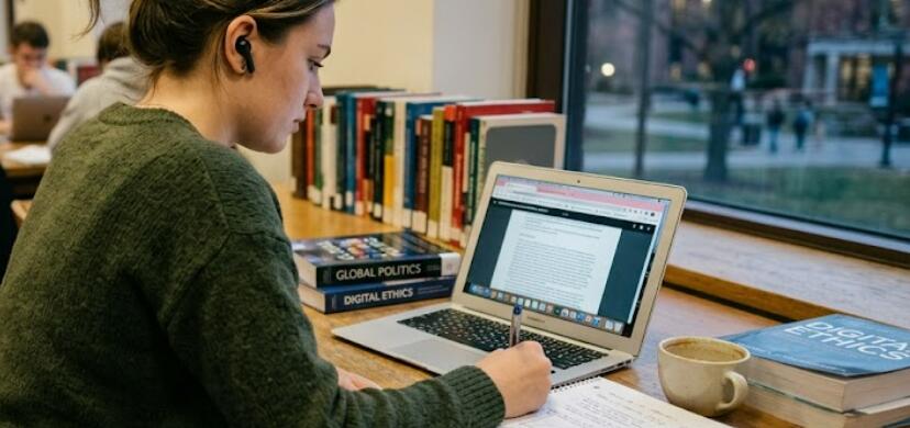 Student using wireless earbuds while studying